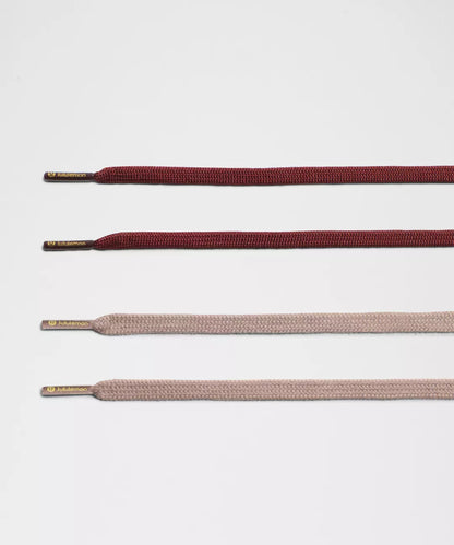 Set of brown and beige shoelaces on a light gray background