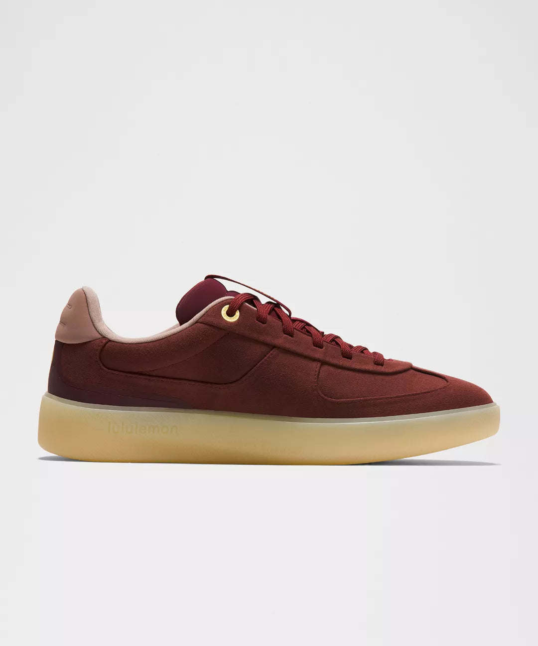 Maroon sneaker with beige sole on a light gray background