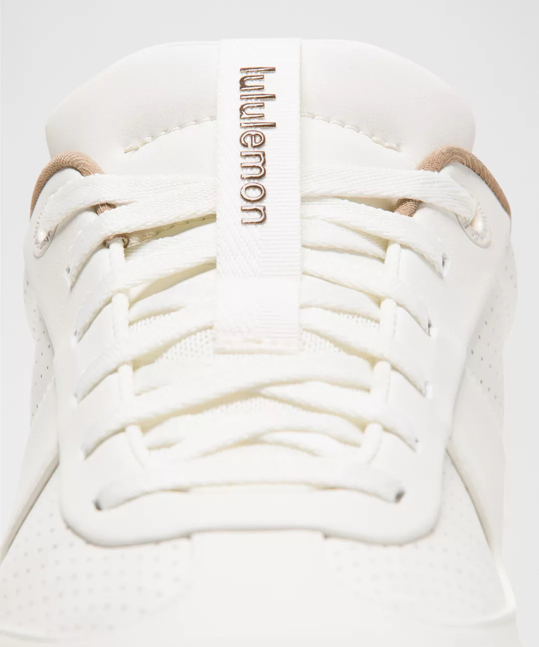 White sneaker with lulu lemon branding on a light gray background