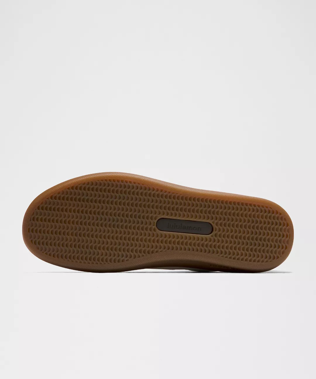 Brown sole of a shoe on a light gray background