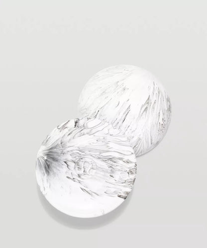 Two clear glass plates with textured surfaces on a light gray background