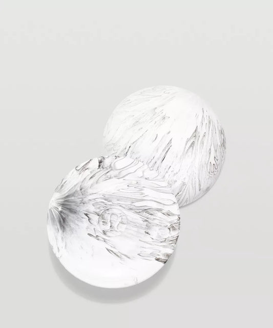 Two clear glass plates with textured surfaces on a light gray background