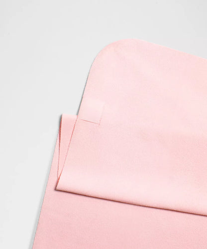 Close-up of a pink fabric texture on a light gray background