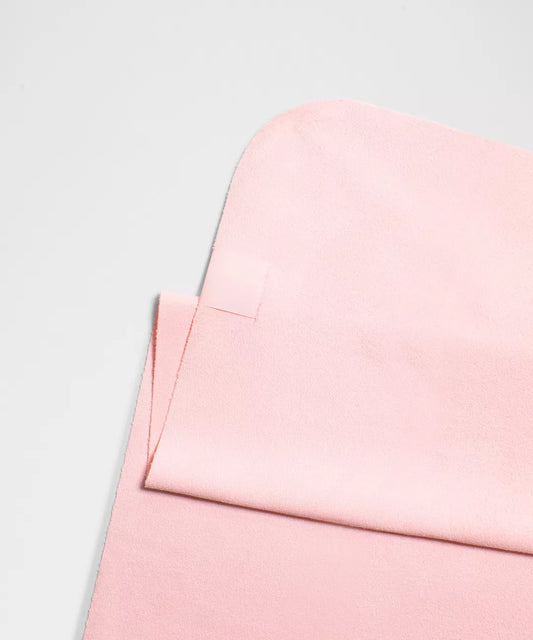 Close-up of a pink fabric texture on a light gray background