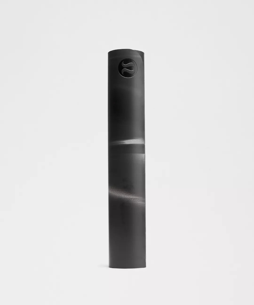 Rolled black yoga mat on a light gray background