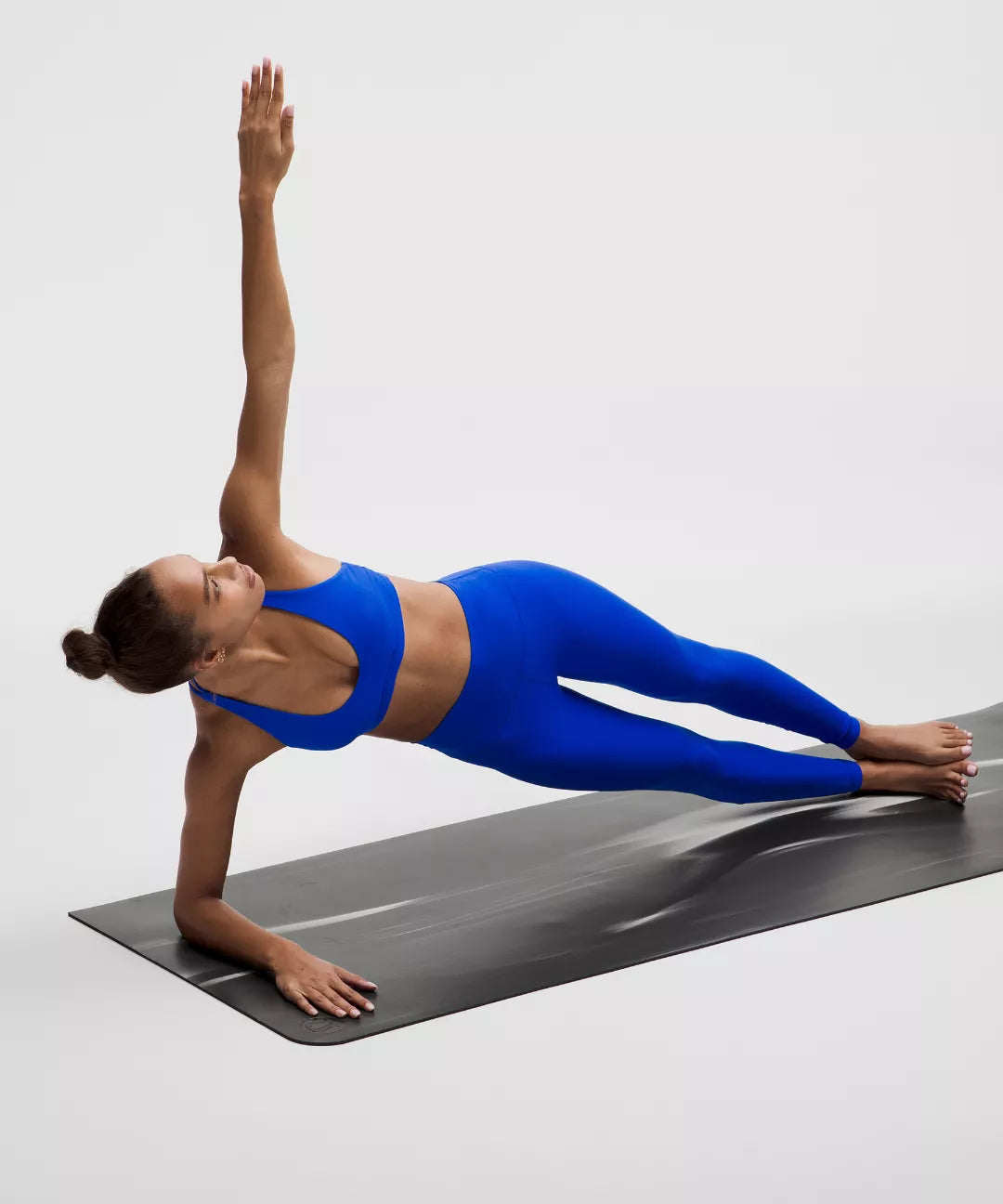 A person on the mat and do yoga with white background