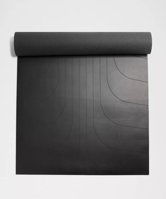 Black yoga mat with a textured pattern on a light gray background