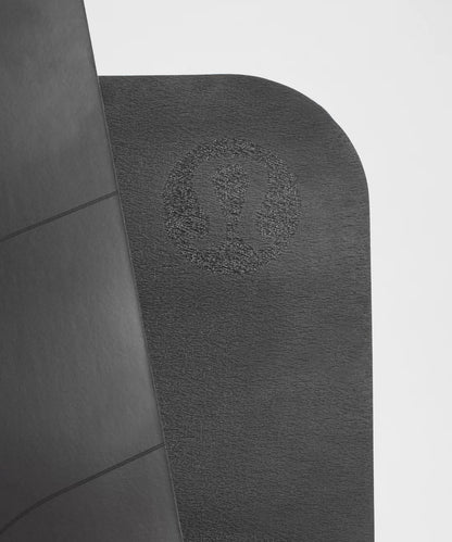 Gray bath mat with a textured pattern on a tiled floor