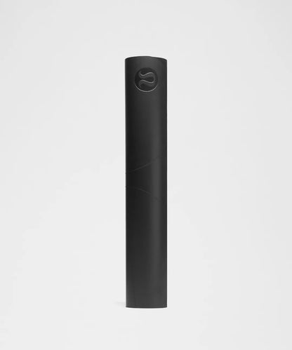 Black yoga mat with a brand logo on a light gray background
