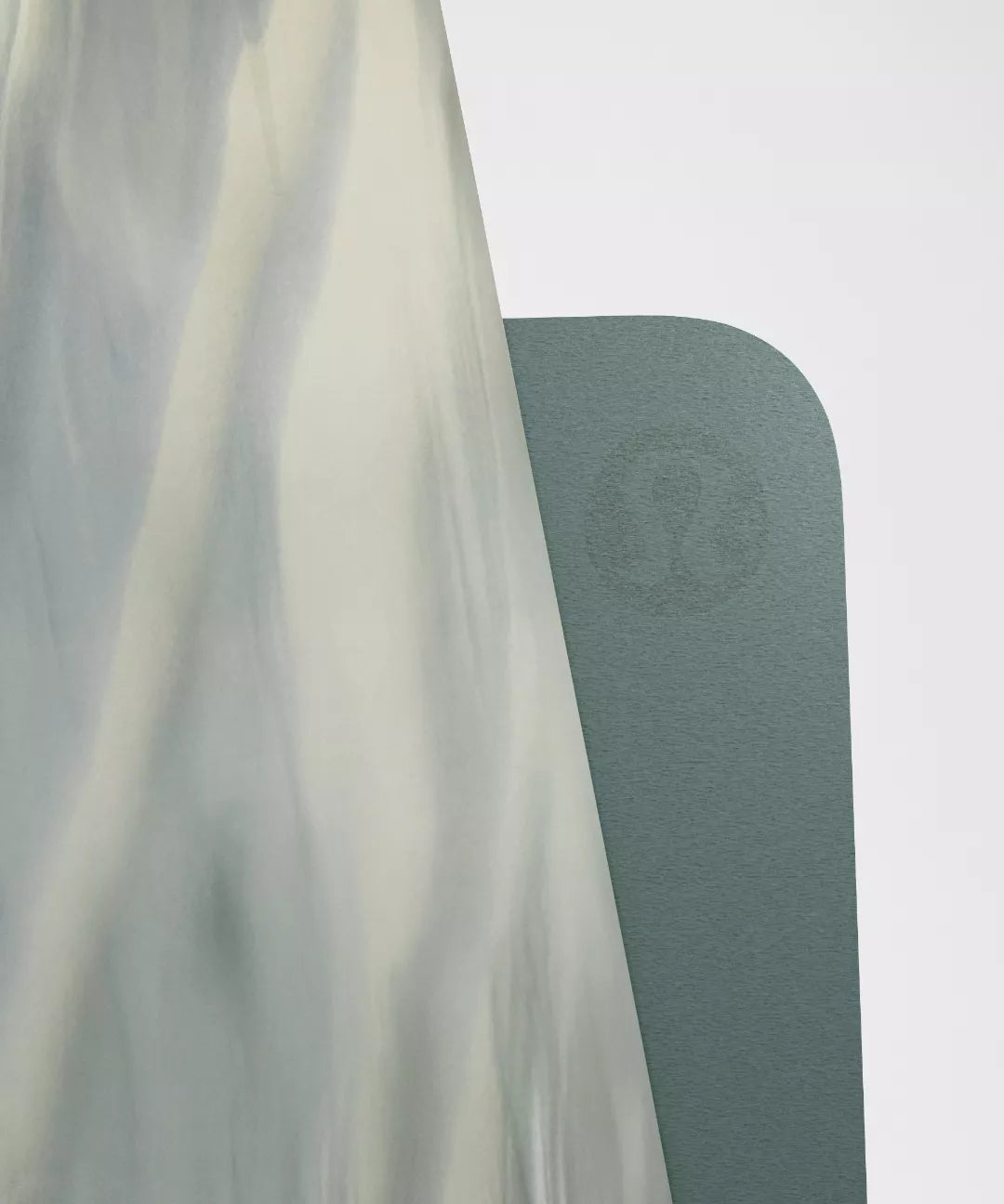 Green yoga mat with a brand logo on a white background