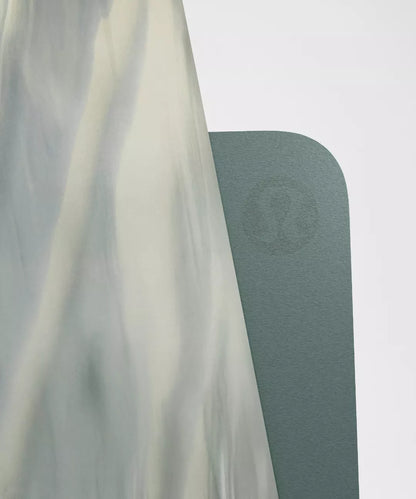 Green yoga mat with a brand logo on a white background
