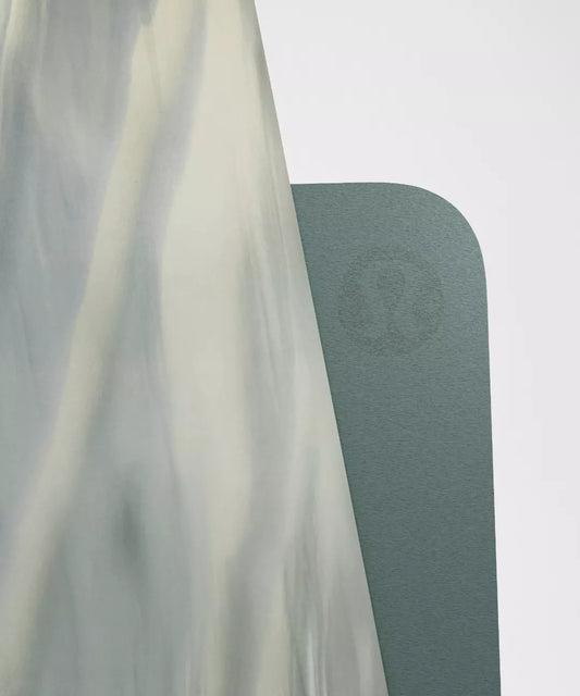 Green yoga mat with a brand logo on a white background