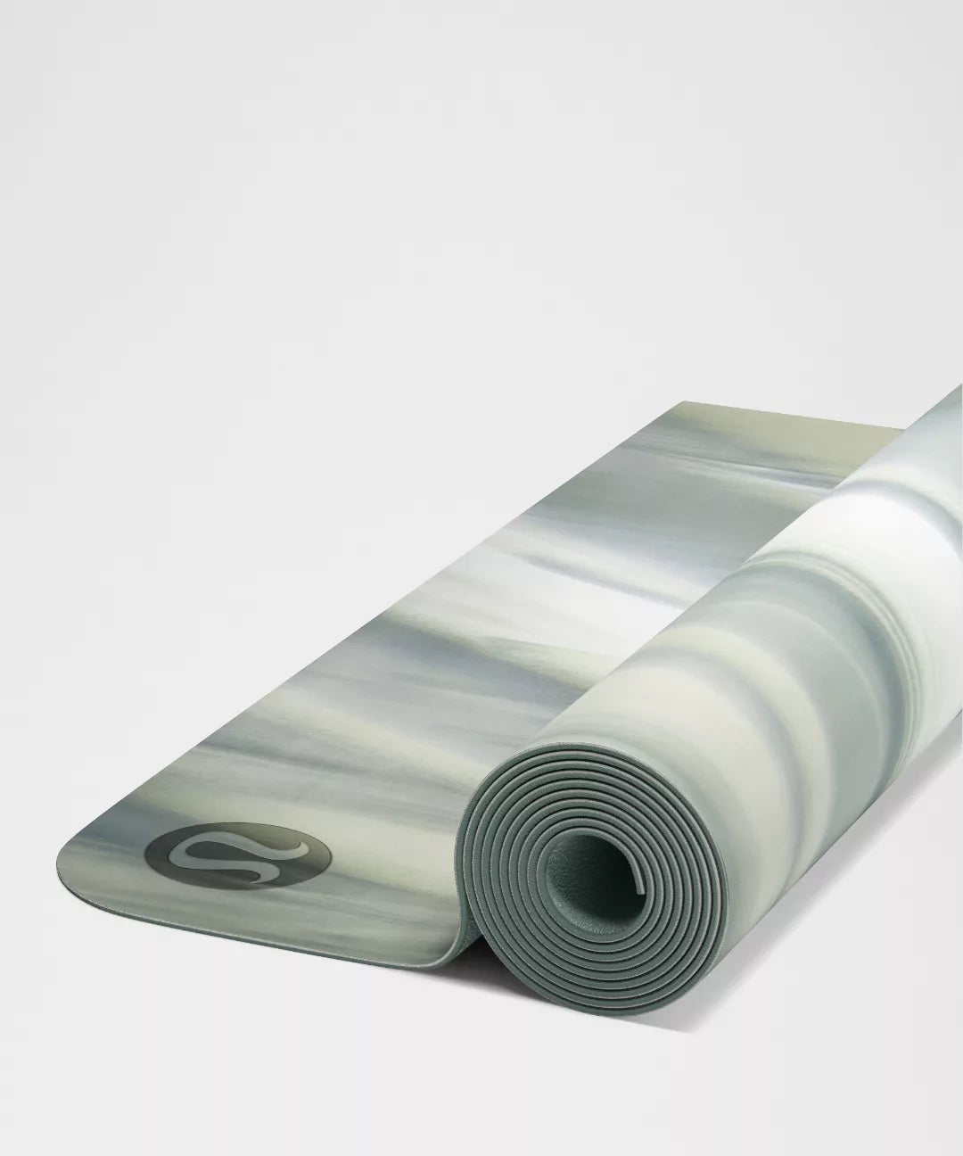 Rolled-up yoga mat with a marbled pattern on a light gray background