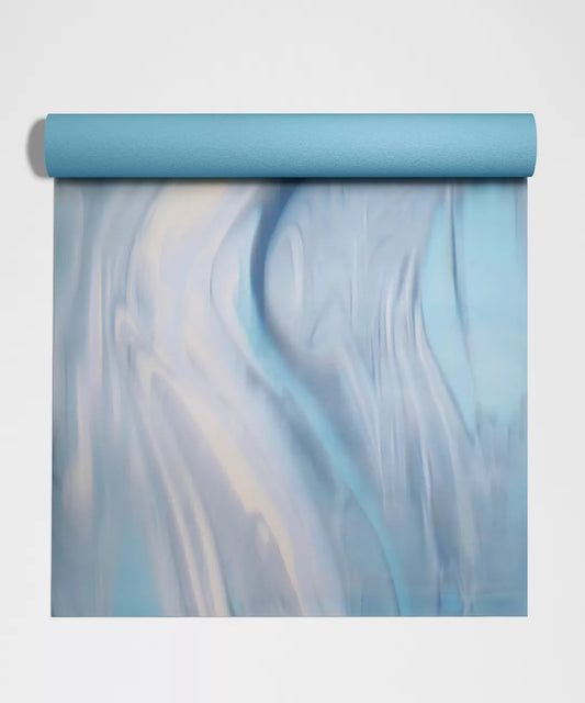 Roll of blue and white marbled paper on a light gray background