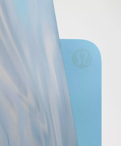 Light blue yoga mat with a brand logo on a white background