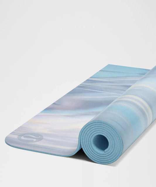 Rolling blue and white striped yoga mat on a light gray background