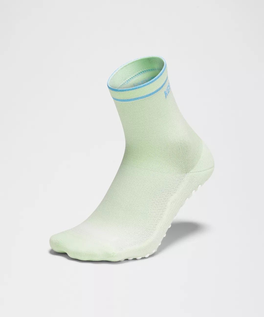 Light green ankle sock with a blue trim on a light gray background