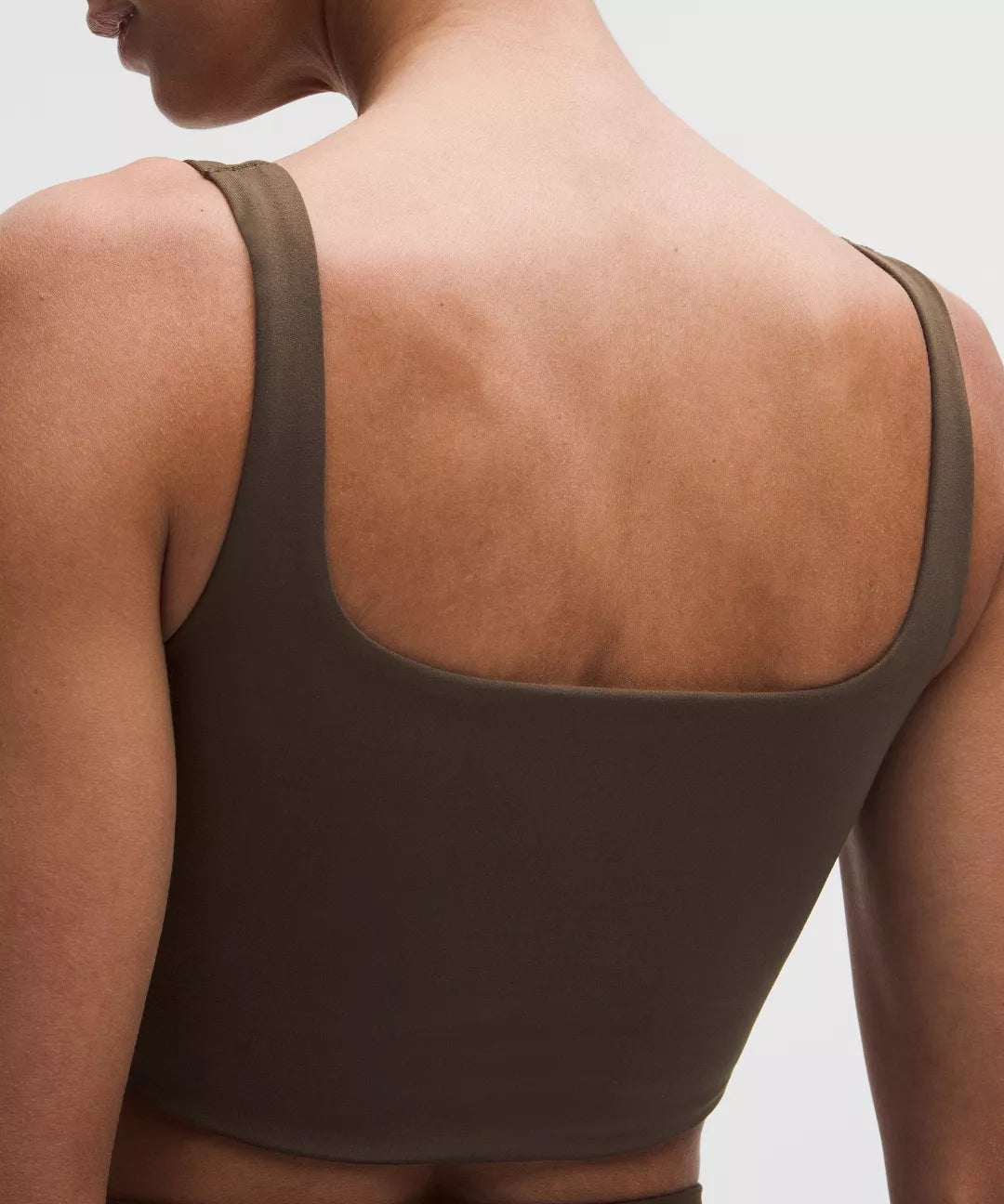 Brown tank top worn by a person on a light gray background