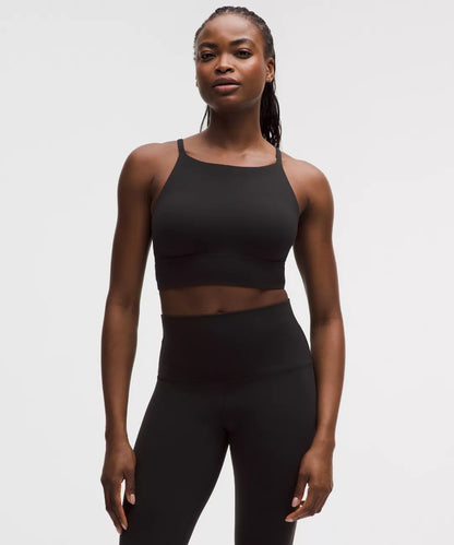 Woman wearing a black athletic outfit on a white background
