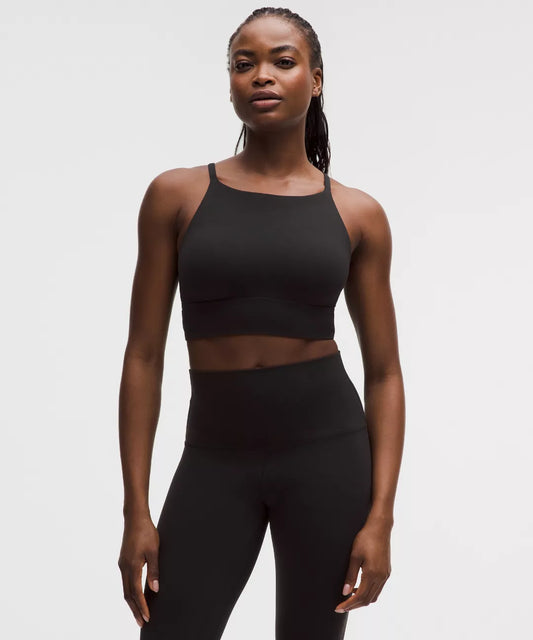 Woman wearing a black athletic outfit on a white background