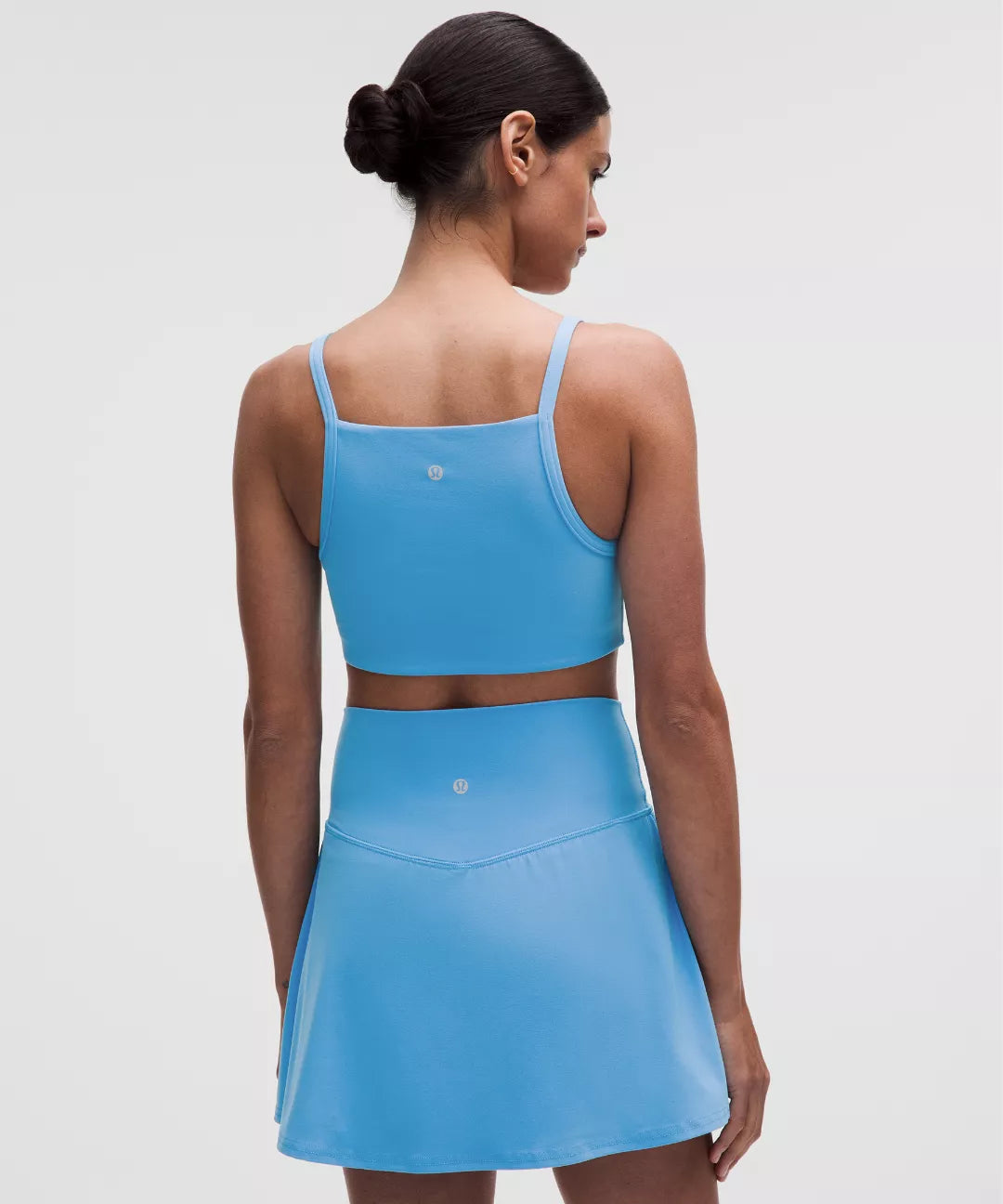 Woman wearing a blue athletic outfit on a white background
