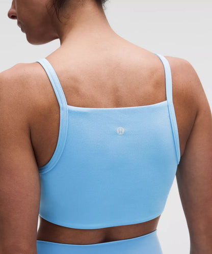 Light blue sports bra worn by a person on a plain background