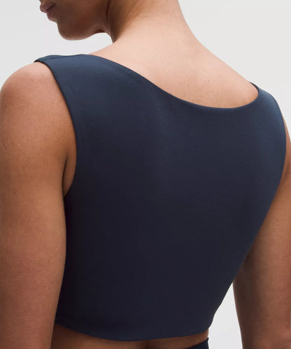Navy blue tank top worn by a person on a light gray background
