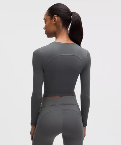 Person wearing a gray athletic outfit on a white background