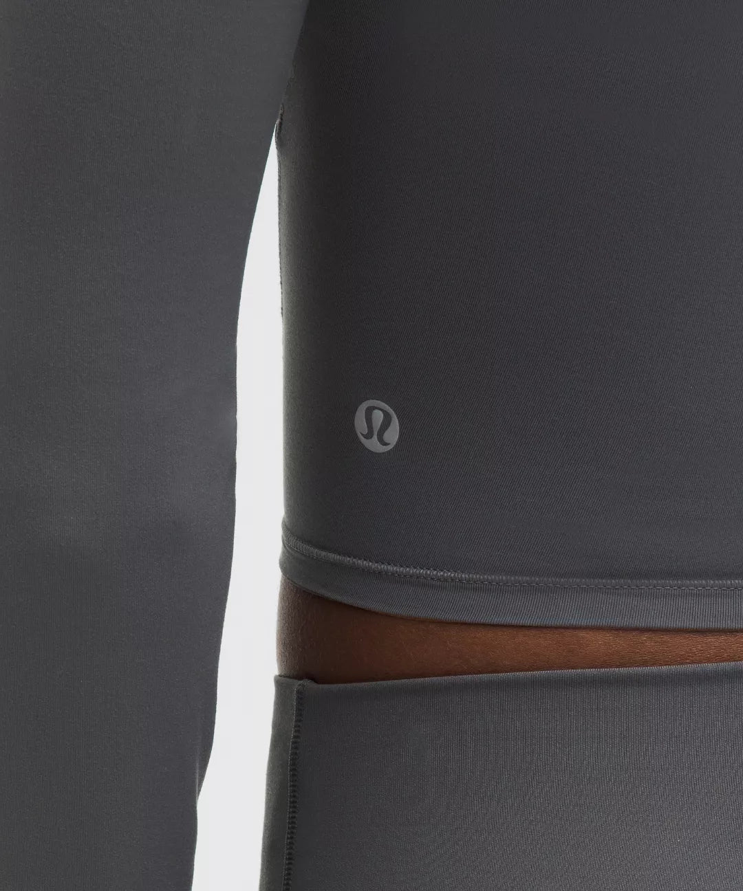 Gray leggings with a brown waistband and Lululemon logo on a white background