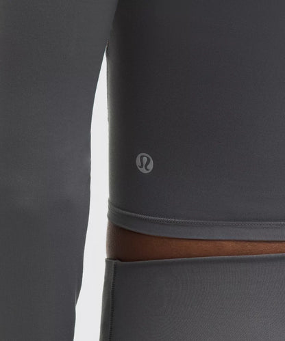 Gray leggings with a brown waistband and Lululemon logo on a white background