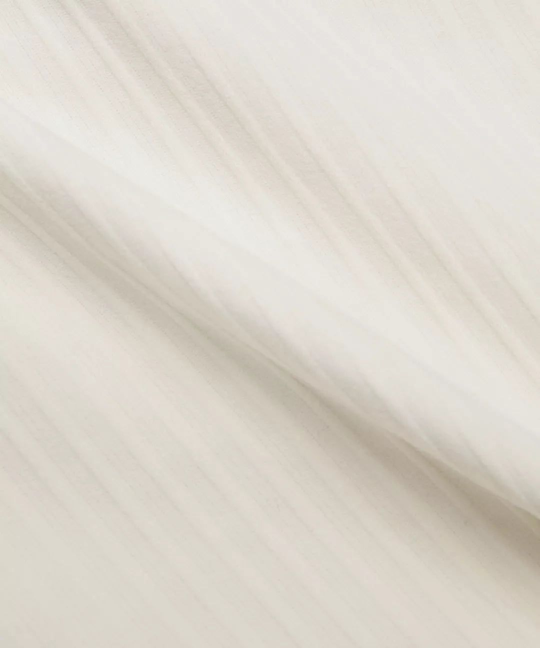 Close-up of beige fabric with a subtle pattern