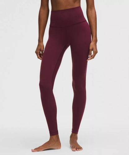 Maroon leggings worn by a person on a white background
