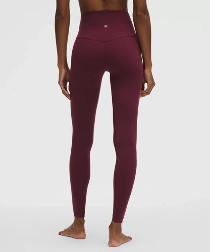 Maroon leggings worn by a person on a white background