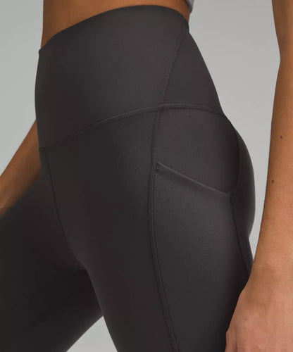 Black leggings worn by a person on a gray background