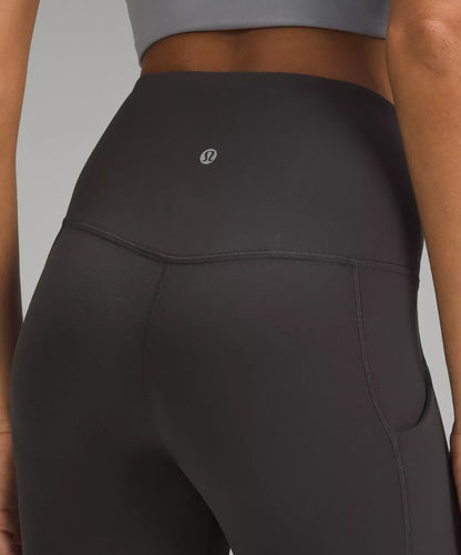 Dark gray leggings with a brand logo on a neutral background