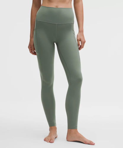 Person wearing green leggings on a white background