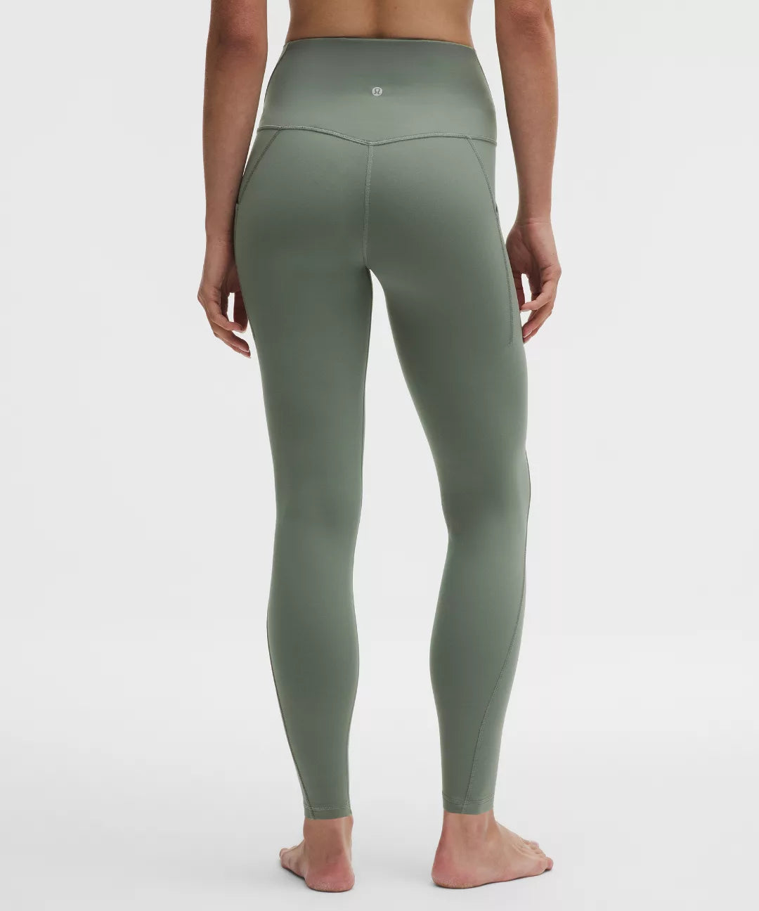 Green leggings worn by a person on a white background
