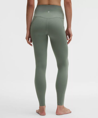Green leggings worn by a person on a white background