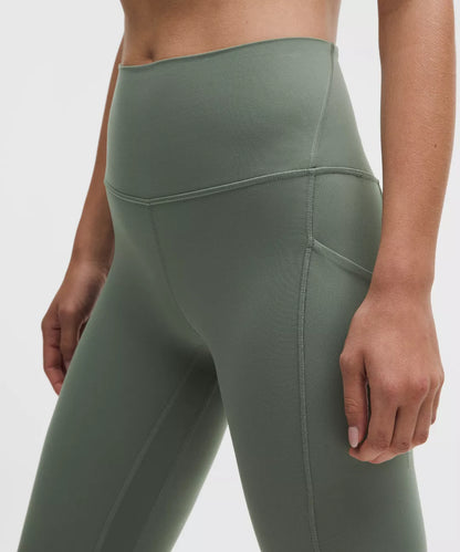 Green leggings worn by a person on a white background