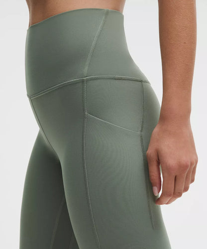 Green leggings worn by a person on a white background