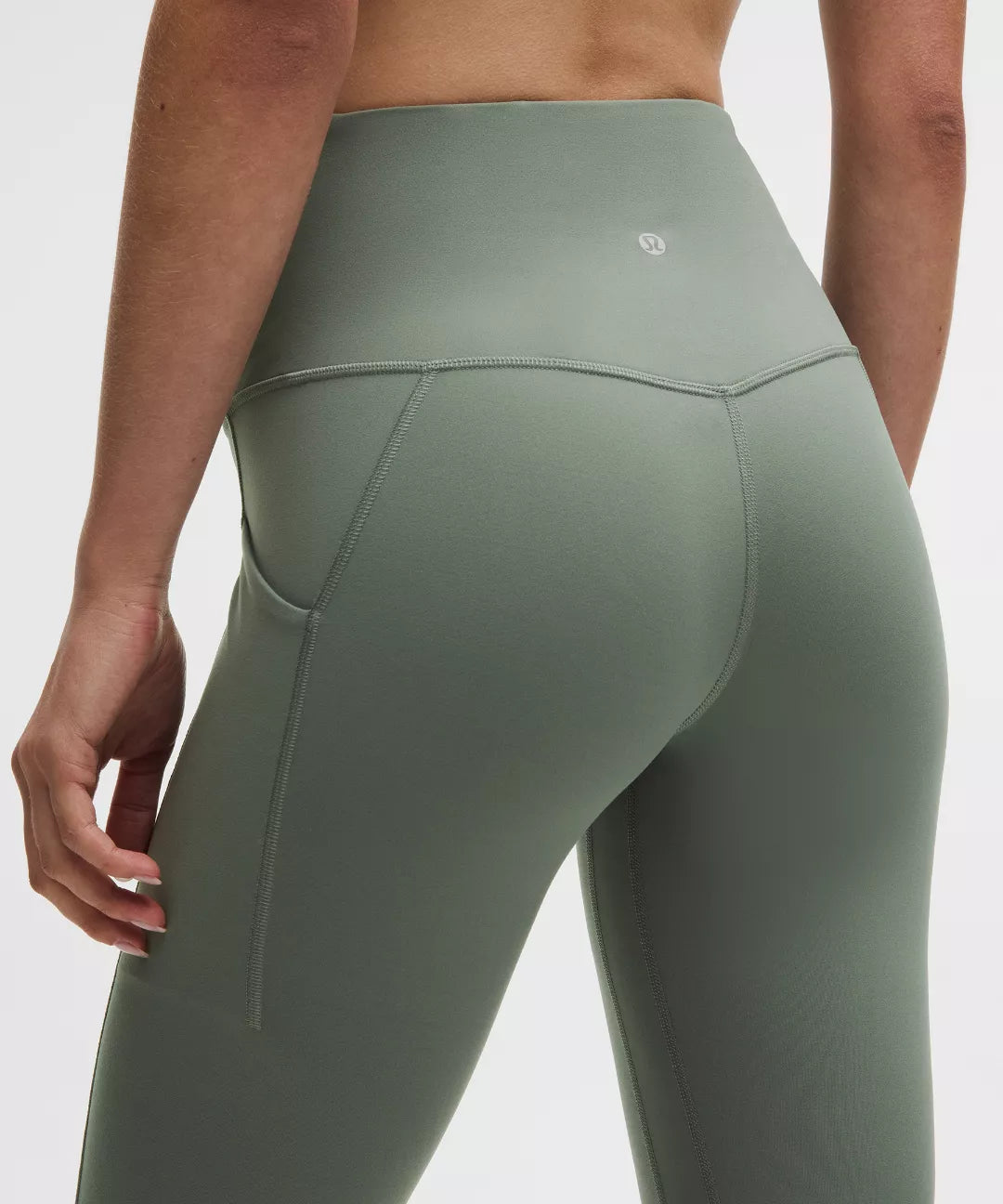 Green leggings worn by a person on a white background