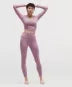 Person wearing a pink athletic outfit with a blurred background