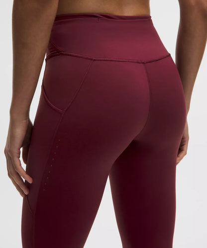 Maroon leggings worn by a person on a white background