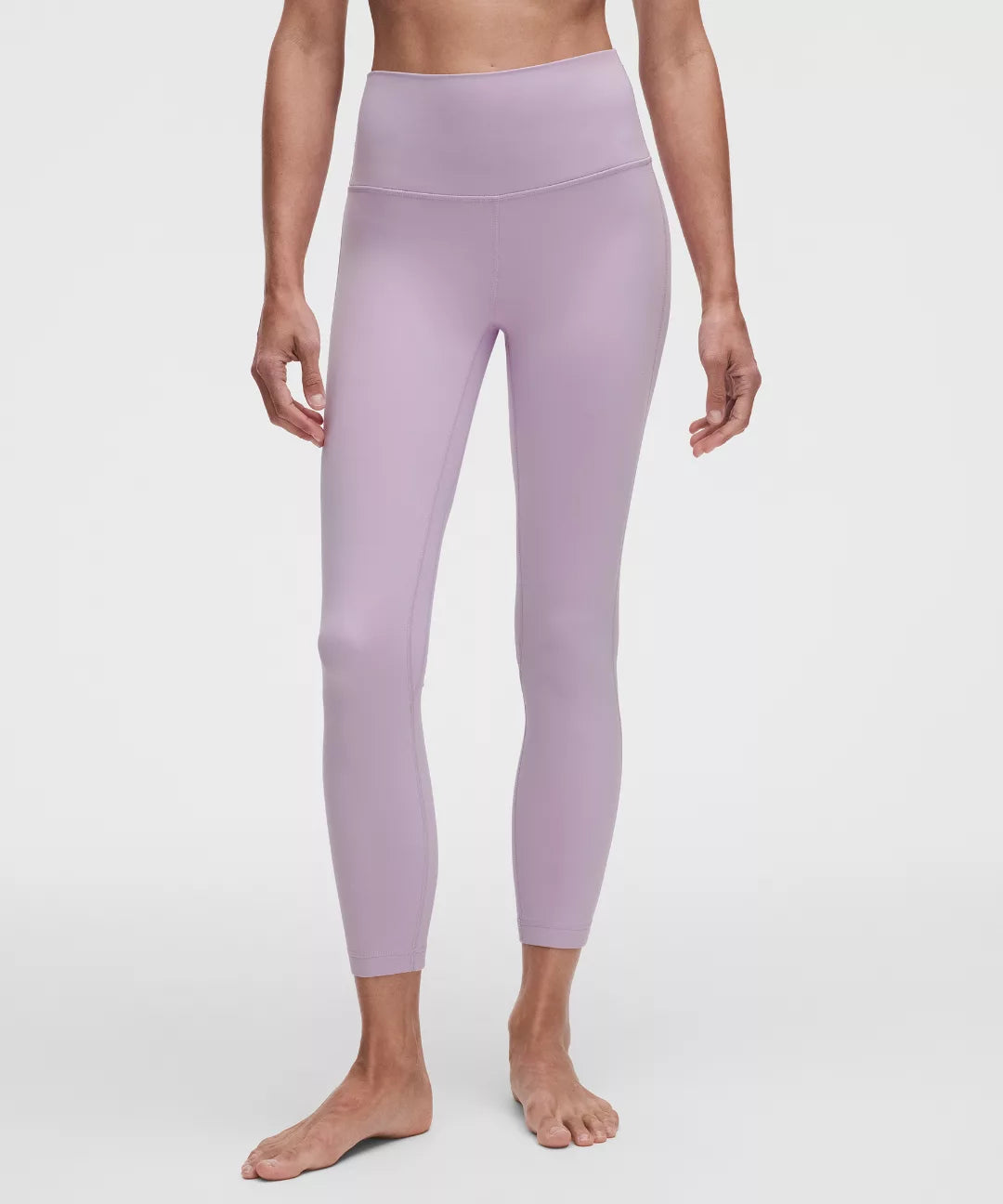Person wearing light purple leggings on a white background