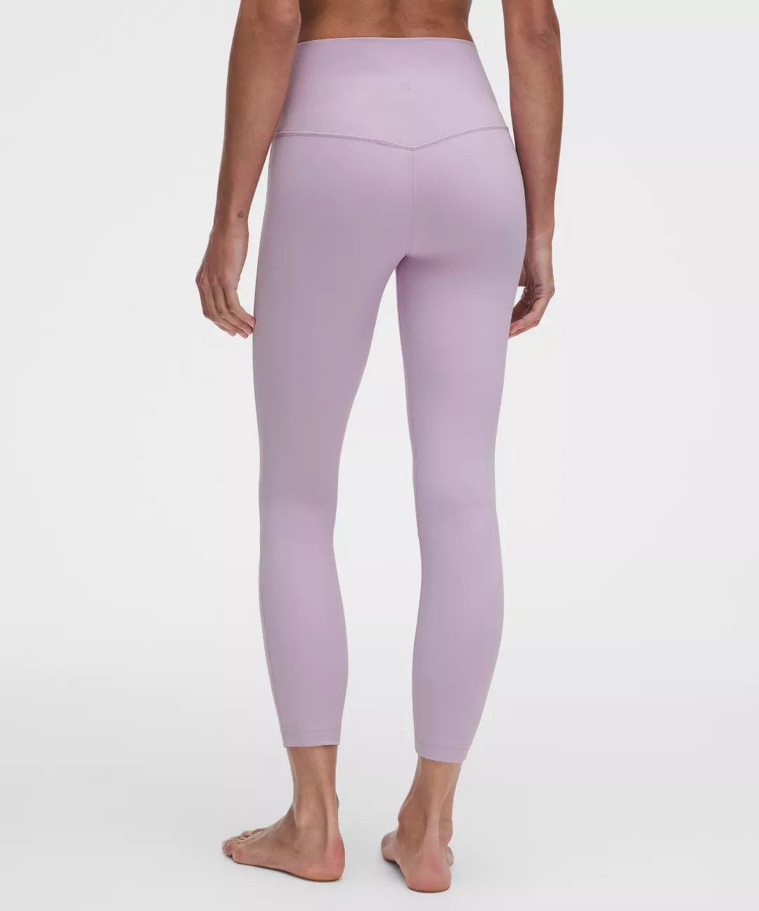 Person wearing lavender leggings on a white background
