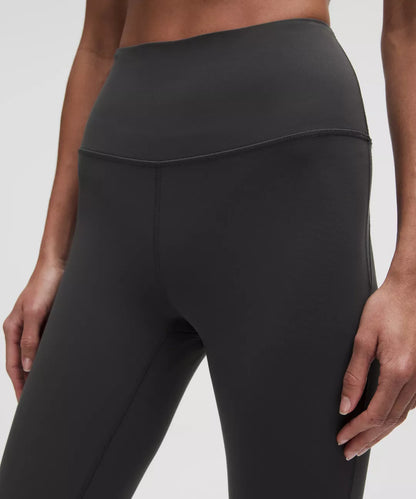 Black leggings worn by a person on a white background