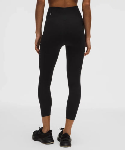 Person wearing black leggings on a white background