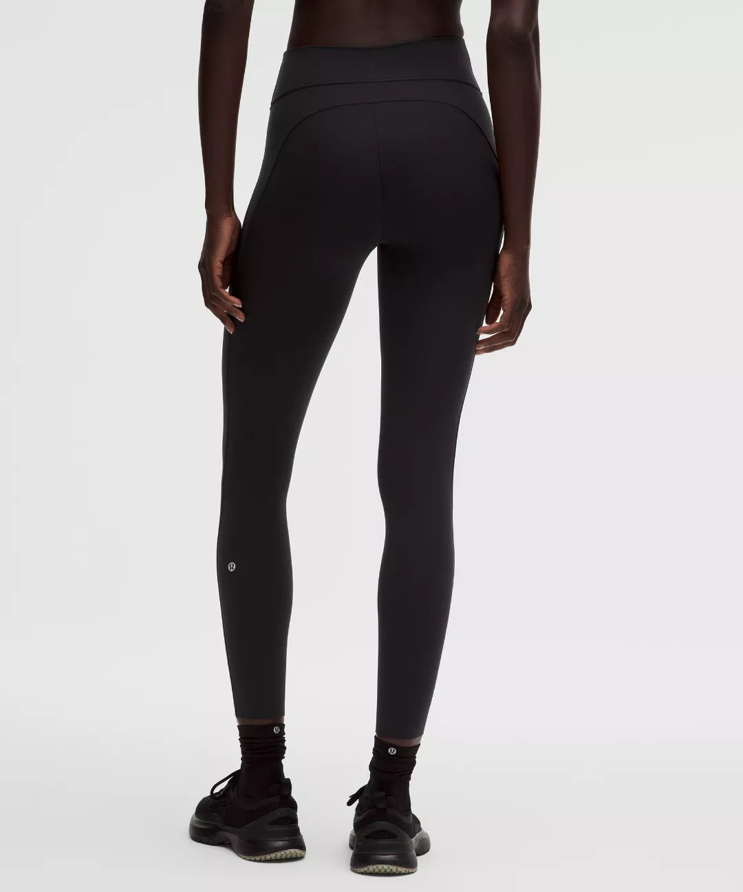 Person wearing black leggings on a white background