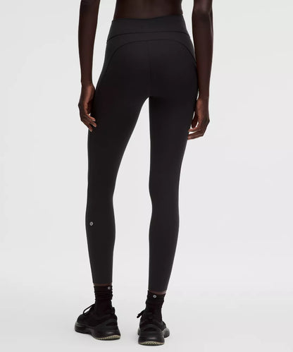 Person wearing black leggings on a white background