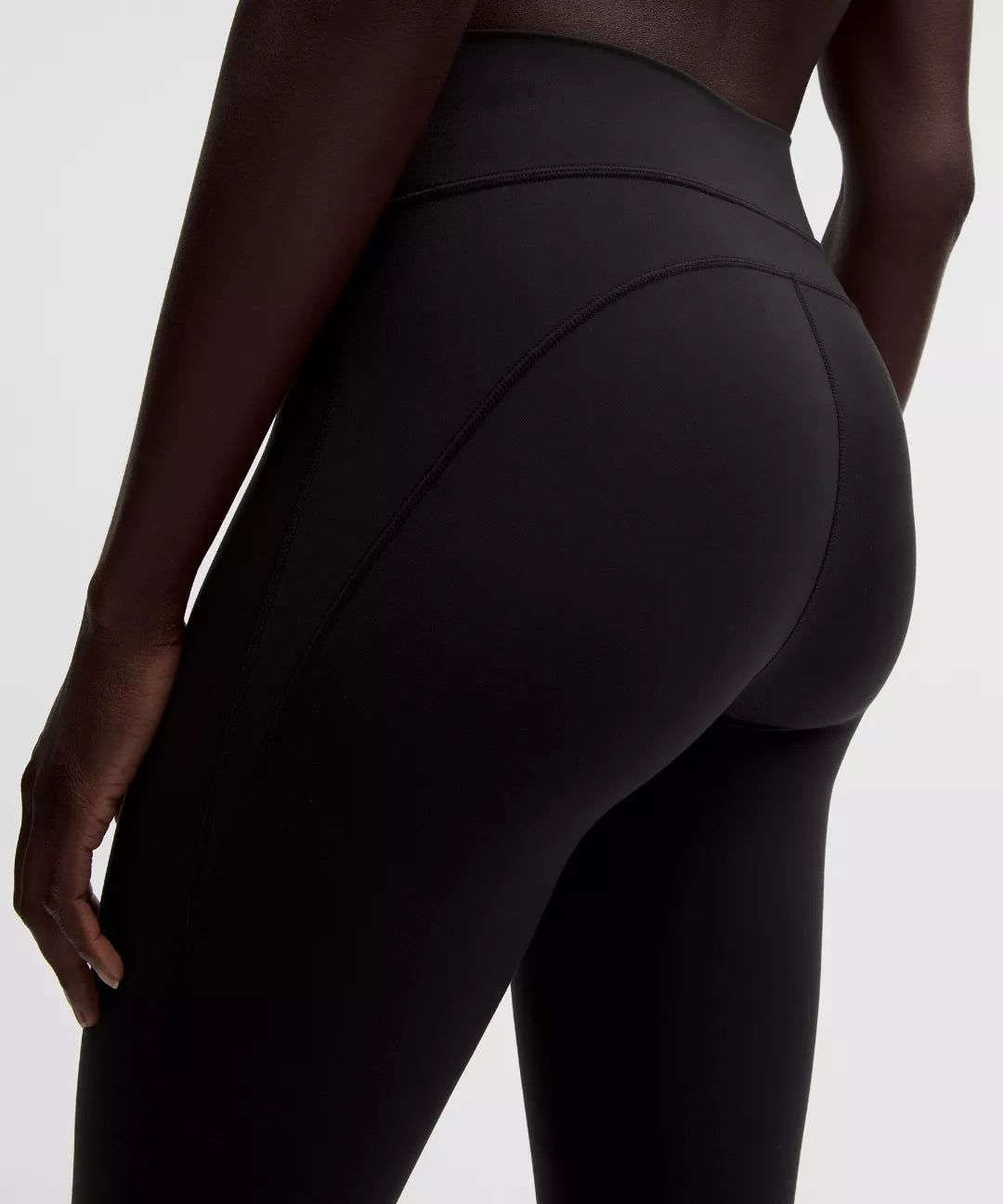 Black leggings worn by a person on a white background